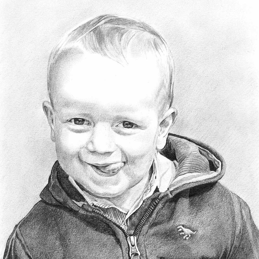Detailed pencil portrait drawing of a smiling young boy, created by a UK-based portrait artist